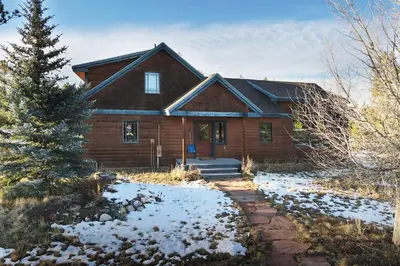 a wooden house with snow in front of it at 383 County Road 508 by Stay Winter Park in Fraser