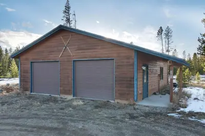a building with two garage doors on the side of it at 383 County Road 508 by Stay Winter Park in Fraser