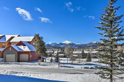 a house in the snow with a christmas tree at Fraser Condo 5 Miles to Winter Park Resort! in Fraser