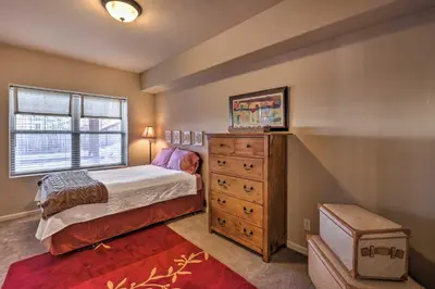 a bedroom with a bed and a dresser and a window at Fraser Condo 5 Miles to Winter Park Resort! in Fraser