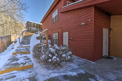 a red house with snow on the side of it at Fraser Condo 5 Miles to Winter Park Resort! in Fraser