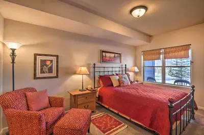a bedroom with a bed and a chair and a window at Fraser Condo 5 Miles to Winter Park Resort! in Fraser