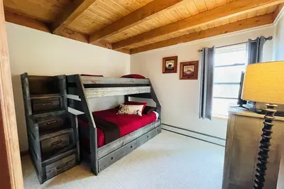 a bedroom with a bunk bed with a red blanket at Ski and Hike Mtn-View Condo in Silverthorne! in Silverthorne