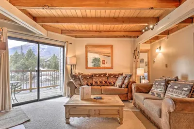 a living room with a couch and a table at Ski and Hike Mtn-View Condo in Silverthorne! in Silverthorne
