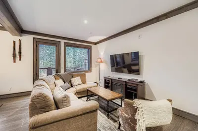 a living room with a couch and a tv at The Seasons 1818 condo in Keystone