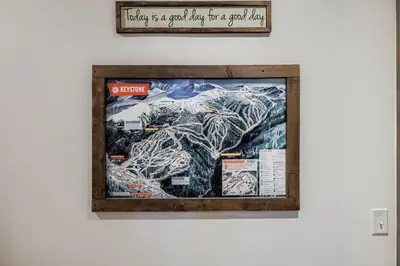 a framed picture of a mountain on a wall at The Seasons 1818 condo in Keystone