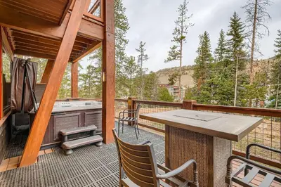 a screened in porch with a table and a grill at The Seasons 1818 condo in Keystone