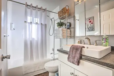 a white bathroom with a sink and a toilet at Duplex with Private Yard 3 Mi to Downtown Loveland! in Loveland