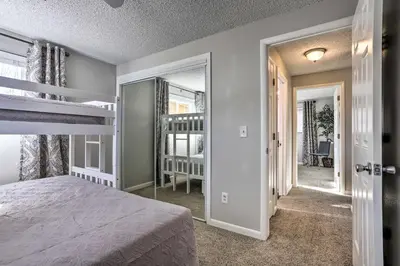 a bedroom with a bunk bed and a staircase at Duplex with Private Yard 3 Mi to Downtown Loveland! in Loveland