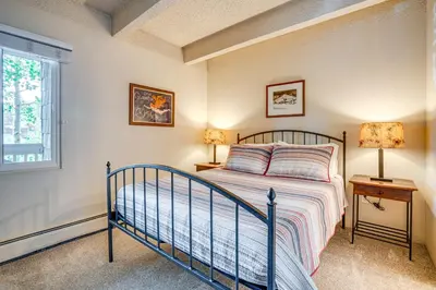 a bedroom with a bed and two lamps and a window at 2 Blocks to Main St Downtown Frisco Condo! in Frisco