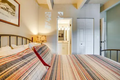 a bedroom with a bed with a colorful blanket at 2 Blocks to Main St Downtown Frisco Condo! in Frisco