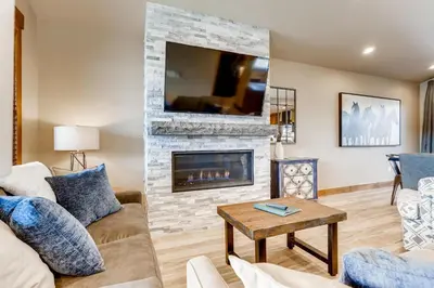 a living room with a fireplace and a tv at Estates on Galena #8 townhouse in Frisco