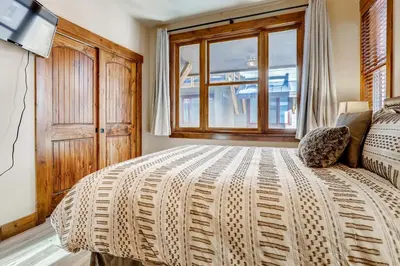 a bedroom with a large bed and a window at Estates on Galena #8 townhouse in Frisco