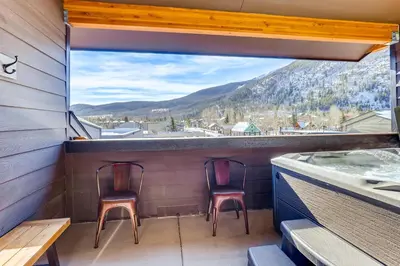 a balcony with two chairs and a hot tub at Estates on Galena #8 townhouse in Frisco