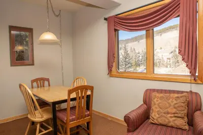 a dining room with a table and chairs and a window at 5016 Gateway condo in Keystone