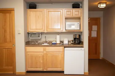 a kitchen with wooden cabinets and a white refrigerator at 5016 Gateway condo in Keystone