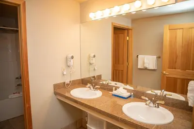 a bathroom with two sinks and a large mirror at 5016 Gateway condo in Keystone