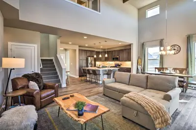 a living room with a couch and a table at Ski and Hike Home with Hot Tub and Gas Grill in Granby in Granby