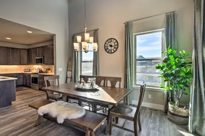 a kitchen and dining room with a table and chairs at Ski and Hike Home with Hot Tub and Gas Grill in Granby in Granby