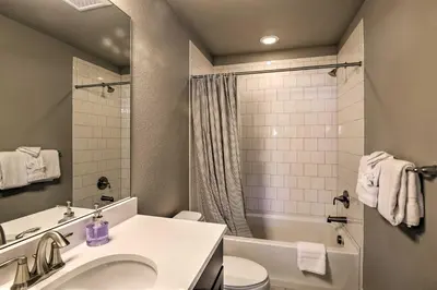 a bathroom with a sink and a toilet and a tub at Ski and Hike Home with Hot Tub and Gas Grill in Granby in Granby