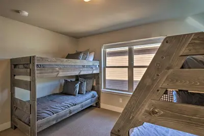 a bedroom with two bunk beds and a window at Ski and Hike Home with Hot Tub and Gas Grill in Granby in Granby