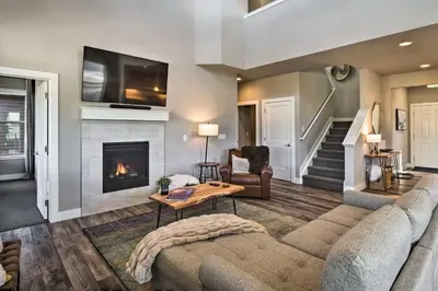 a living room with a couch and a fireplace at Ski and Hike Home with Hot Tub and Gas Grill in Granby in Granby