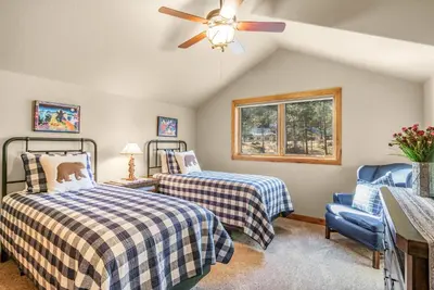 a bedroom with two beds and a ceiling fan at River Rock Retreat -- EV #6032 condo in Estes Park