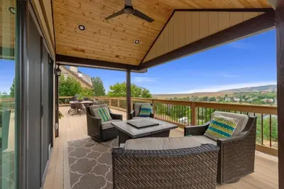 a patio with chairs and a table on a deck at Outstanding Home, Incredible Views, Near Reservoir in Fort Collins