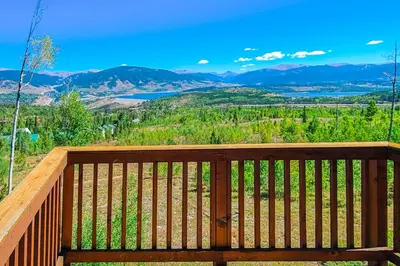 a wooden bench on a deck with a view at Prospector Village 105C in Silverthorne