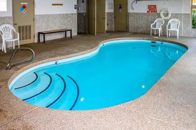 a large swimming pool with chairs and a table at Prospector Village 105C in Silverthorne