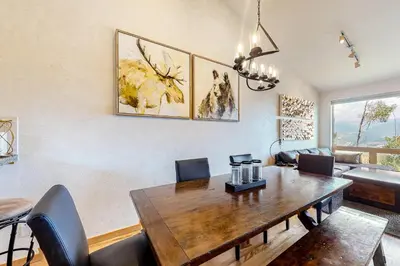 a dining room with a wooden table and chairs at Prospector Village 105C in Silverthorne