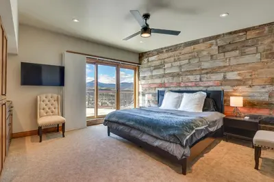 a bedroom with a brick wall and a bed and a window at Mountain Adventure Home Base - Ski, Hike and Chill! in Fraser