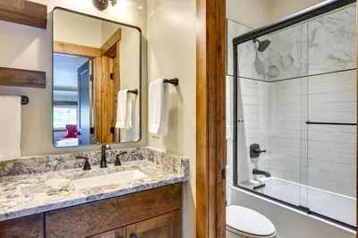 a bathroom with a sink and a toilet and a mirror at Mountain Adventure Home Base - Ski, Hike and Chill! in Fraser