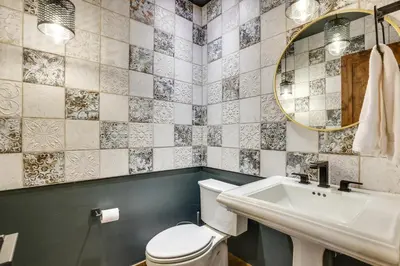 a bathroom with a toilet and a sink and a mirror at Mountain Adventure Home Base - Ski, Hike and Chill! in Fraser