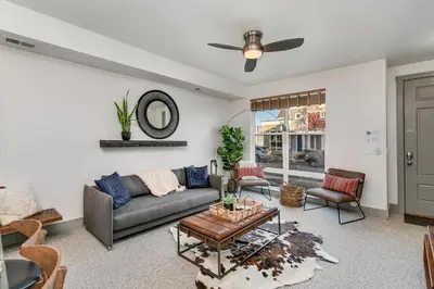 a living room with a couch and a table at Old Town North Jewel! Near Breweries and River! in Fort Collins