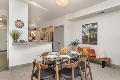 a dining room and living room with a table and chairs at Old Town North Jewel! Near Breweries and River! in Fort Collins