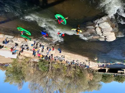 a group of people standing on a beach near the water at Old Town North Jewel! Near Breweries and River! in Fort Collins