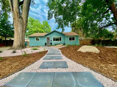 a walkway in front of a blue house at Fun, Family-Friendly Old Town Home with Hot Tub! in Fort Collins