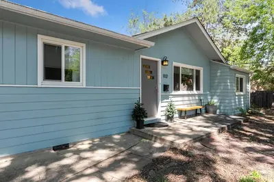 a blue house with a bench in front of it at Fun, Family-Friendly Old Town Home with Hot Tub! in Fort Collins