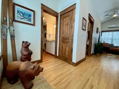 a living room with two wooden bears on the wall at The Beautiful Bears Den! Walk to Old Town and CSU! in Fort Collins