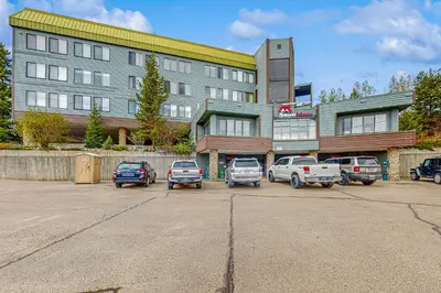 a parking lot with cars parked in front of a building at Snowblaze Condominiums C14 in Winter Park