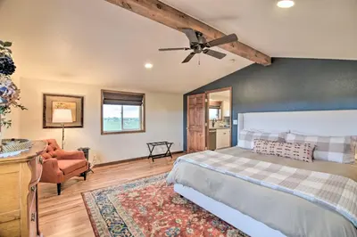 a bedroom with a bed and a ceiling fan at Lovely Barn Loft with Mountain Views on Horse Estate in Fort Collins