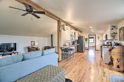 a living room with a blue couch and a kitchen at Lovely Barn Loft with Mountain Views on Horse Estate in Fort Collins