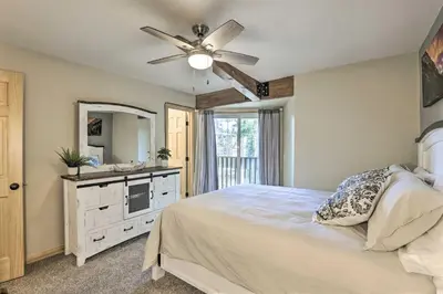 a bedroom with a bed and a ceiling fan at Cozy Winter Park Condo, Walk to Ski Shuttle! in Winter Park