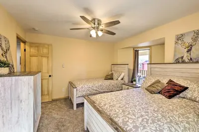 a bedroom with two beds and a ceiling fan at Cozy Winter Park Condo, Walk to Ski Shuttle! in Winter Park