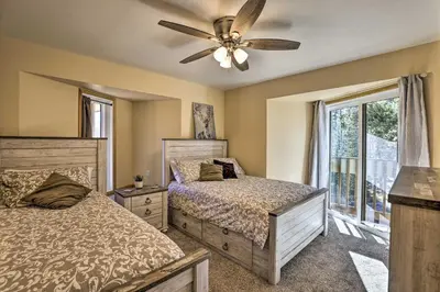 a bedroom with two beds and a ceiling fan at Cozy Winter Park Condo, Walk to Ski Shuttle! in Winter Park