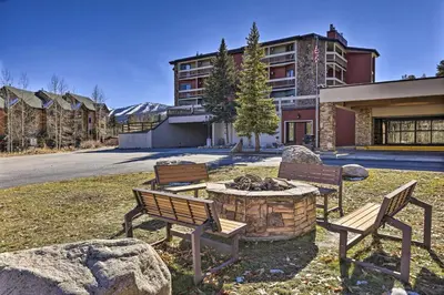 a group of benches sitting in front of a fire pit at Cozy Winter Park Condo, Walk to Ski Shuttle! in Winter Park