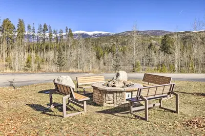 three park benches sitting next to a fire pit at Cozy Winter Park Condo, Walk to Ski Shuttle! in Winter Park