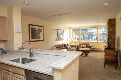 a kitchen with a sink and a living room at 1538 Lakeshore condo in Dillon