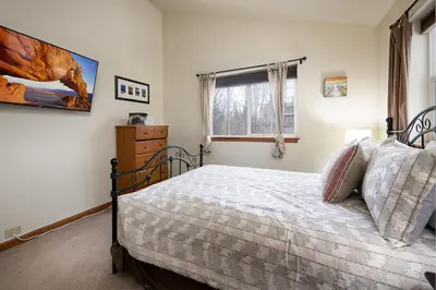 a bedroom with a bed and a window at Sungate Condo: Nice Frisco Location in Frisco
